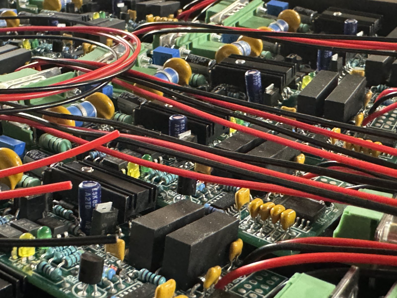 Wiring looms routed across populated printed circuit boards