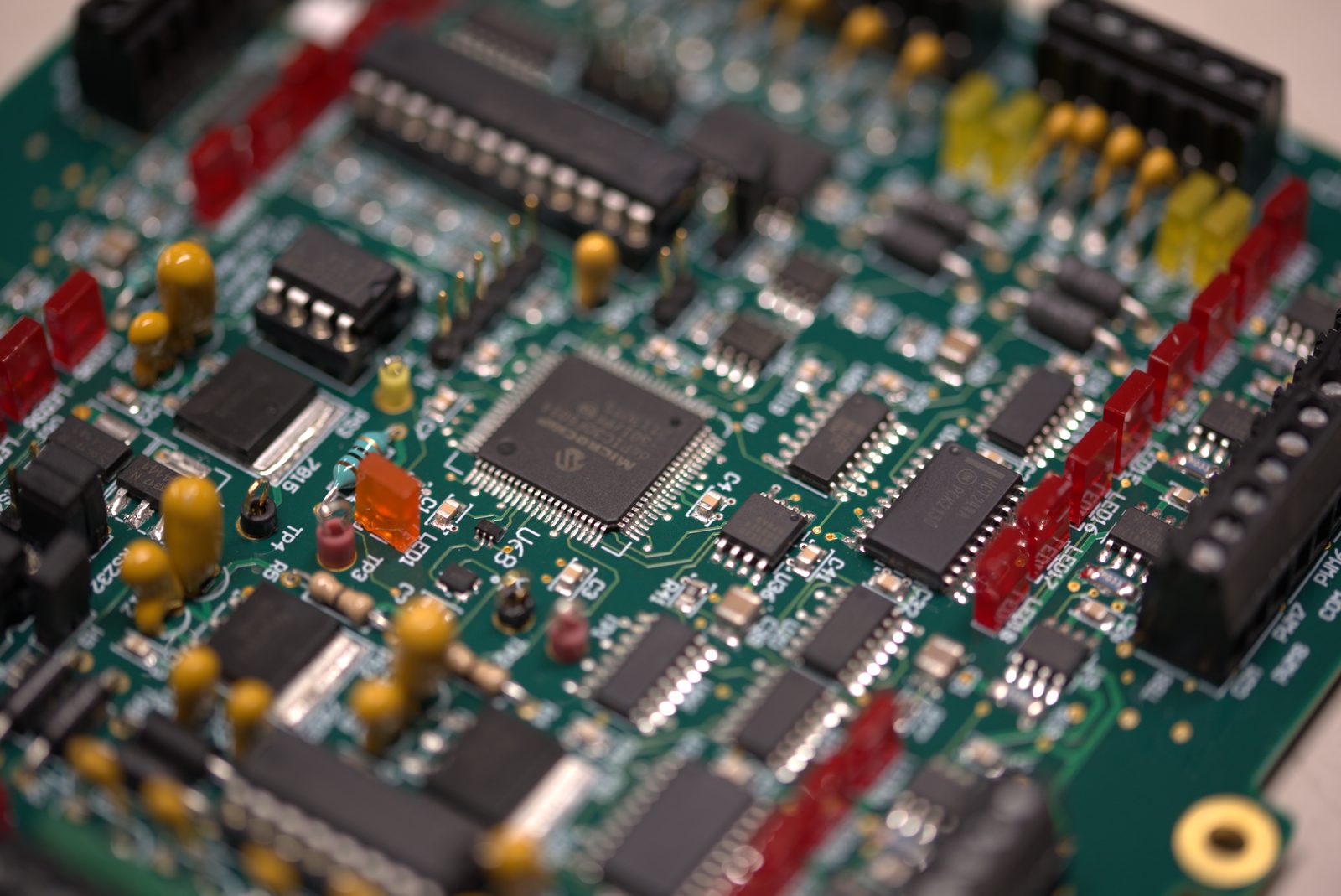 Close-up of a populated printed circuit board with surface-mount and through-hole components